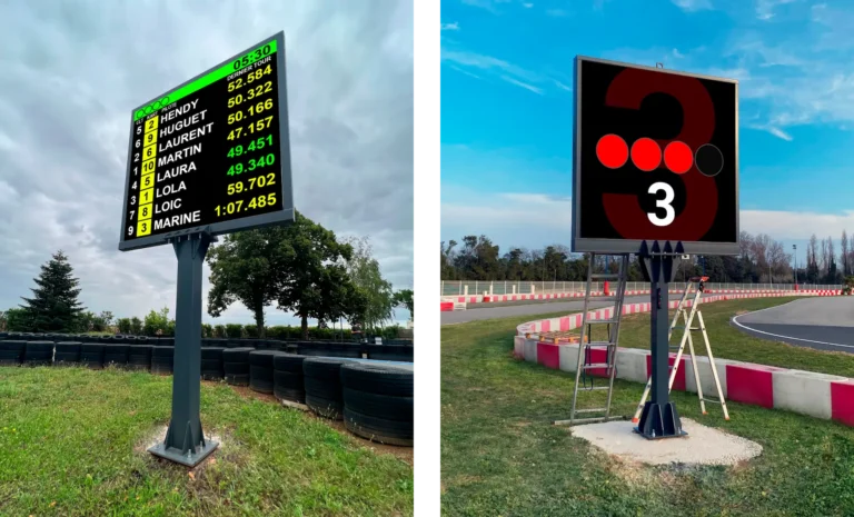 Écrans LED sur mât en bord de piste affichant un classement puis des feux de départ