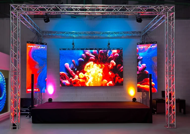 Event LED wall mounted on a stage truss, with two side displays