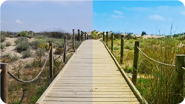 Wooden boardwalk through dunes shown dull on the left and vividly saturated on the right