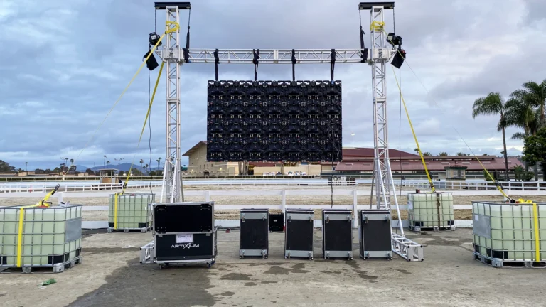 Rear view of an outdoor LED display, with water ballast and tower lifts