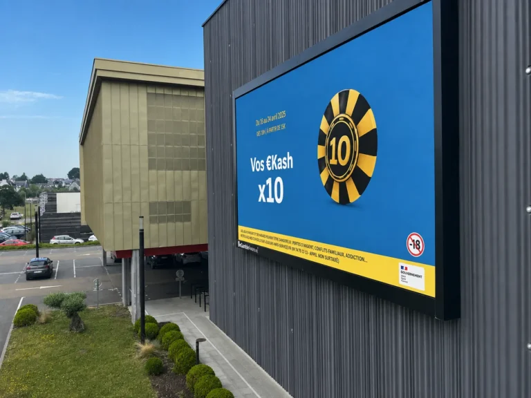 Side view of the Kasino LED display running a blue Vos Kash x10 promotion with a casino chip