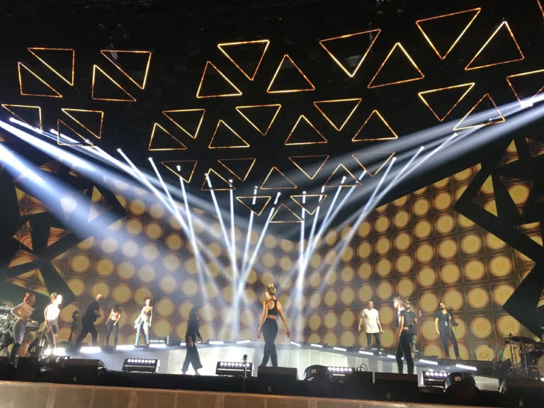 LED triangles suspended above the stage, dancers and light beams during the show