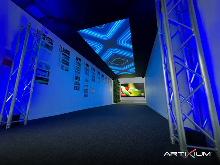 Artixium showroom: corridor with a blue LED ceiling beside a company timeline wall