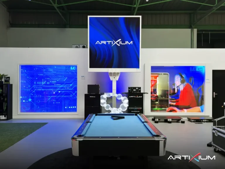 Pool table facing a suspended LED screen with the logo and two wall-mounted LED displays