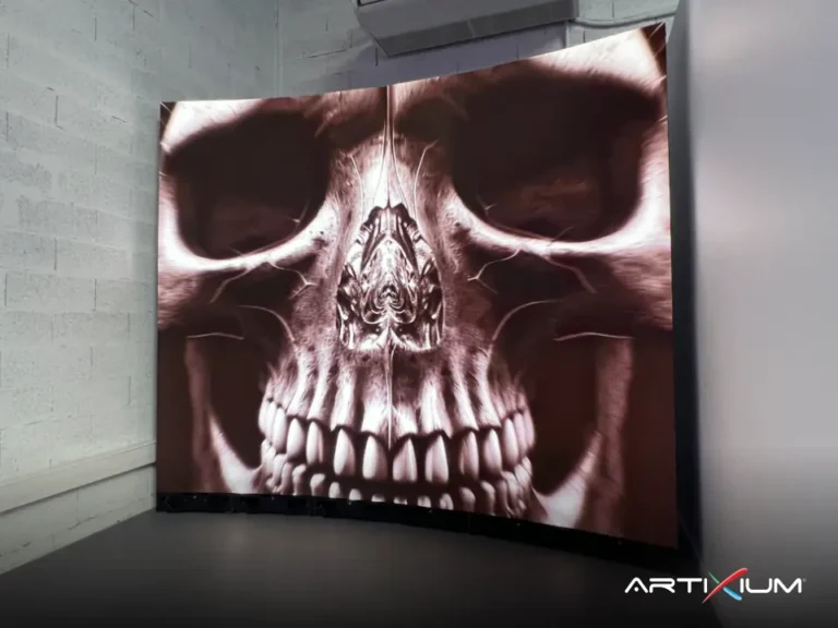 Curved LED wall set in a room corner displaying a skull in extreme close-up