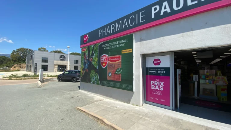 LED screen pharmacy – LED display on the Pharmacie Paolini facade running an ad, vertical screen visible in the window