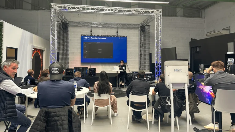 Technical presentation in front of an LED display, with a seated audience