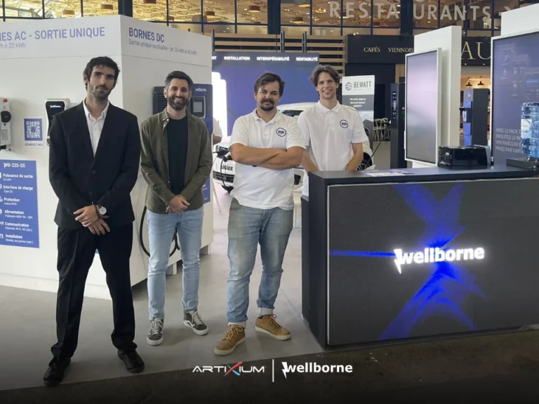 LED screen motor show – Four people beside a counter clad in LED panels showing a logo on the exhibition stand