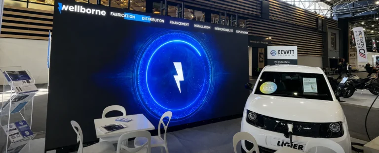 Large stand LED video wall running a blue light animation, electric car plugged in alongside