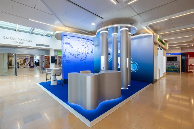 LED screen booth – Curved blue LED video wall wrapping the ABG Lab retail corner inside a Monaco shopping gallery