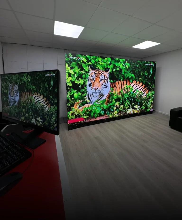 Virtual-production studio LED wall showing a tiger image, with the control desk in the foreground