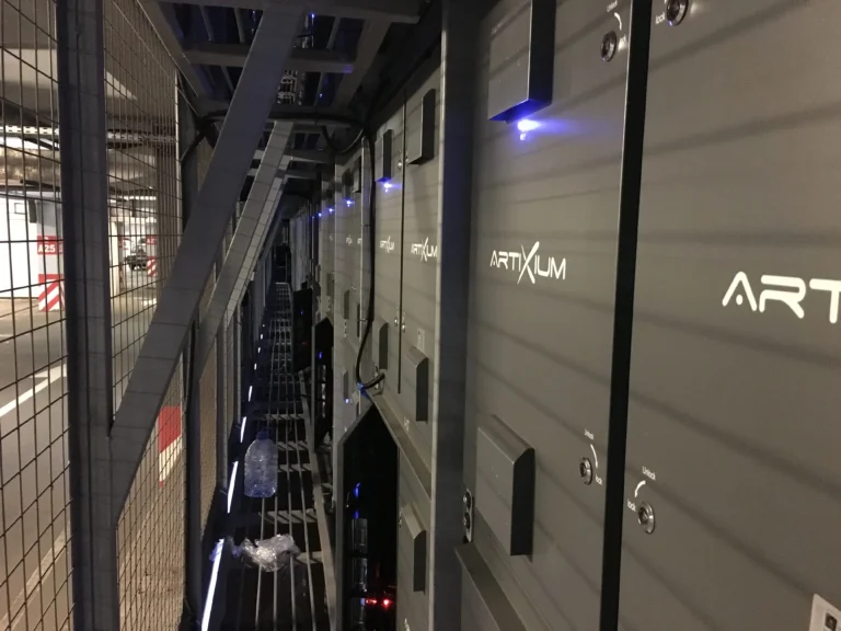 Rear of the Artixium LED cabinets along the maintenance walkway, blue status indicators lit