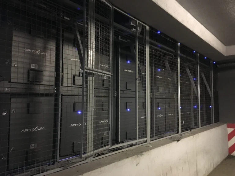 Back of the Artixium LED cabinets behind a protective mesh fence in the building’s technical level