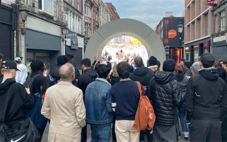 LED screen portal Dublin – Crowd gathered on a Dublin shopping street in front of the circular LED portal